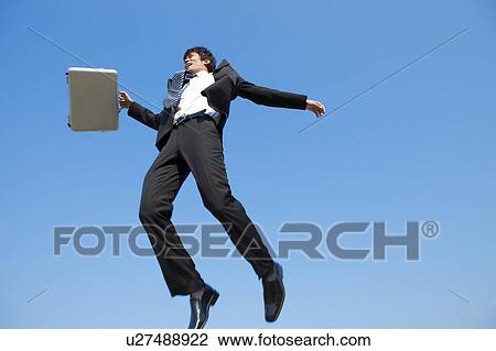 Businessman jumping with briefcase View Large Photo Image Stock Image - Businessman jumping with briefcase. Fotosearch