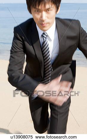 Businessman running at beach View Large Photo Image Stock Photography - Businessman running at beach. Fotosearch
