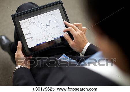 Businessman using a digital tablet View Large Photo Image Stock Photography - Businessman using a digital tablet. Fotosearch