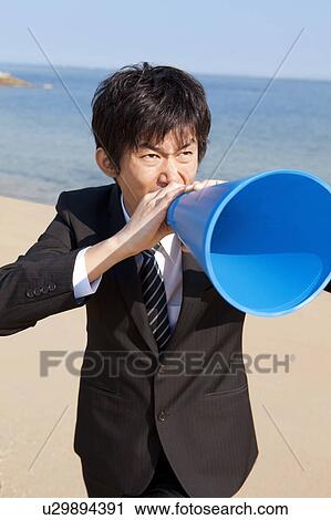 Stock Image - Businessman using a megaphone. Fotosearch