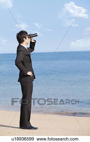 Businessman using binoculars View Large Photo Image Stock Photo - Businessman using binoculars. Fotosearch