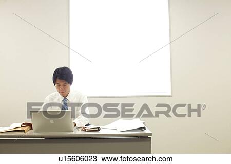 Stock Image - Businessman using laptop. Fotosearch