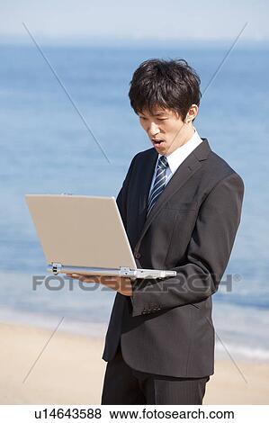 Businessman using laptop View Large Photo Image Stock Photo - Businessman using laptop. Fotosearch