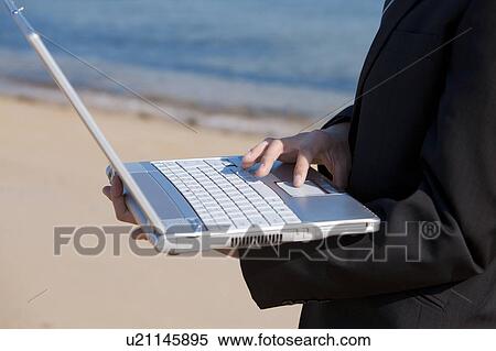 Businessman using laptop View Large Photo Image Stock Photography - Businessman using laptop. Fotosearch