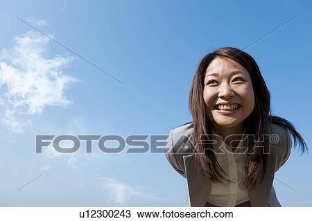 Stock Image - Businesswoman bending over. Fotosearch