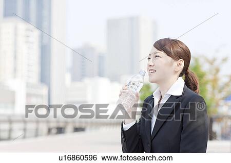 Stock Photograph - Businesswoman Drinking Water. Fotosearch