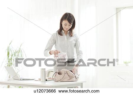 Stock Photograph - Businesswoman Taking Lunch Box Out. Fotosearch