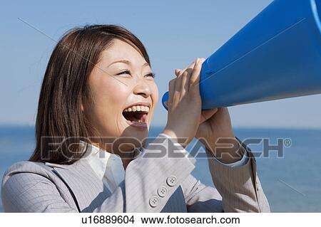 Businesswoman using a megaphone View Large Photo Image Picture - Businesswoman using a megaphone. Fotosearch