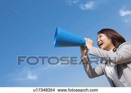 Businesswoman using a megaphone View Large Photo Image Picture - Businesswoman using a megaphone. Fotosearch