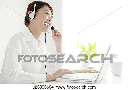 Picture - Businesswoman Using Internet Phone. Fotosearch
