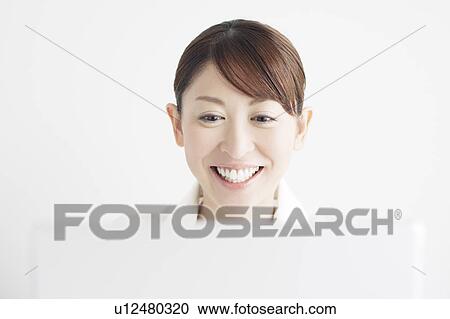Stock Image - Businesswoman Using Laptop. Fotosearch