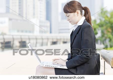 Stock Image - Businesswoman Using Laptop. Fotosearch