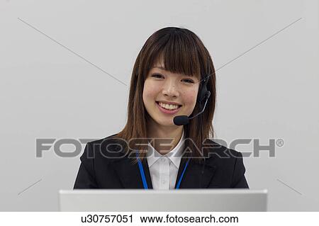 Stock Image - Businesswoman with headset. Fotosearch