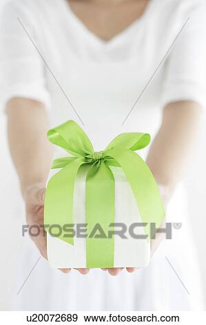 Close Up of Young Woman Holding Gift View Large Photo Image Stock Photo - Close Up of Young Woman Holding Gift. Fotosearch