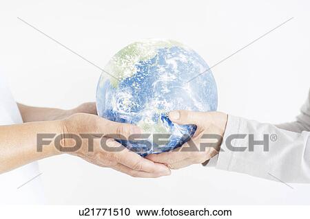 Stock Image - Couple Holding Globe. Fotosearch