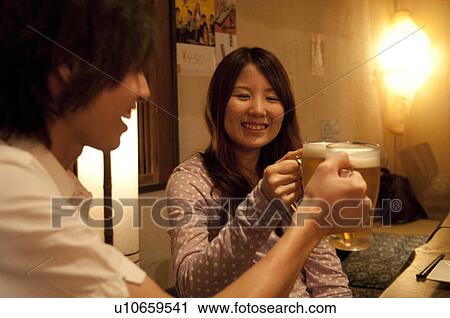 Couple toasting with beer View Large Photo Image Stock Image - Couple toasting with beer. Fotosearch