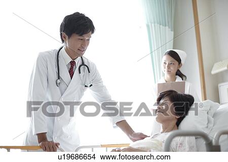Doctor and Nurse with Patient View Large Photo Image Picture - Doctor and Nurse with Patient. Fotosearch
