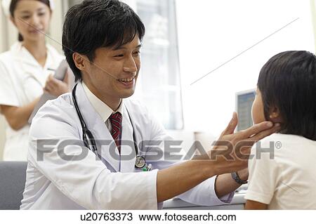 Stock Image - Doctor Examining Boy. Fotosearch