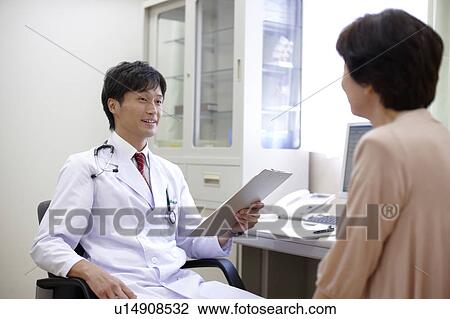 Stock Image - Doctor Examining Patient. Fotosearch