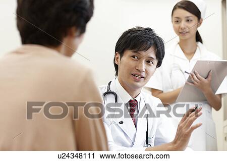 Stock Image - Doctor Talking to Patient. Fotosearch