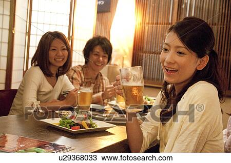 Friends at a bar View Large Photo Image Stock Image - Friends at a bar. Fotosearch