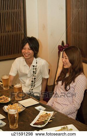 Friends at a bar View Large Photo Image Stock Photo - Friends at a bar. Fotosearch