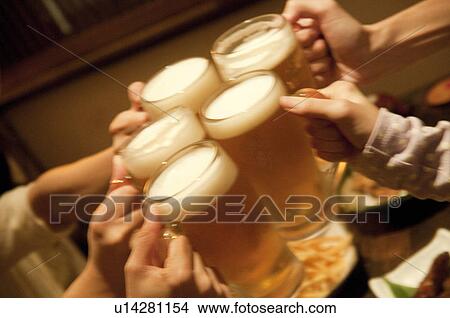 Picture - Friends toasting at a bar. Fotosearch