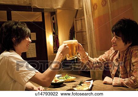 Friends toasting at a bar View Large Photo Image Stock Image - Friends toasting at a bar. Fotosearch