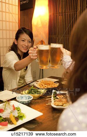 Stock Photo - Friends toasting at a bar. Fotosearch