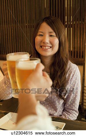Friends toasting at a bar View Large Photo Image Stock Photography - Friends toasting at a bar. Fotosearch