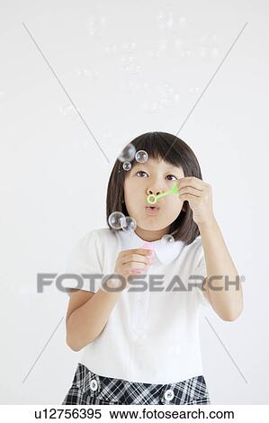 Stock Photography - Girl Blowing Bubbles. Fotosearch
