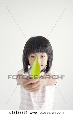 Stock Image - Girl Holding Leaf. Fotosearch