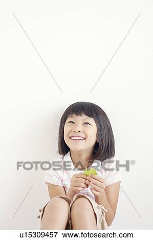 Stock Photo - Girl Holding Leaf. Fotosearch