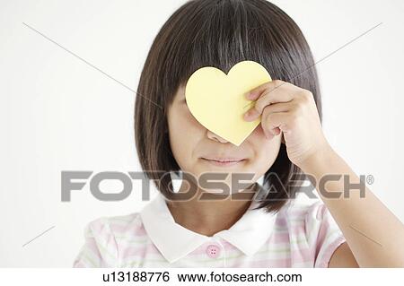 Girl Holding Love Heart on Her Face View Large Photo Image Stock Photograph - Girl Holding Love Heart on Her Face. Fotosearch