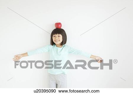 Girl with Apple On Her Head View Large Photo Image Stock Image - Girl with Apple On Her Head. Fotosearch