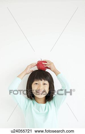 Girl with Apple On Her Head View Large Photo Image Stock Image - Girl with Apple On Her Head. Fotosearch