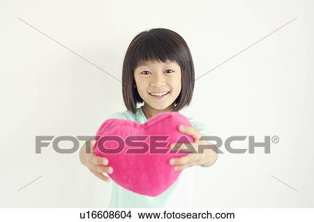 Picture - Girl with Heart Shaped Cushion. Fotosearch