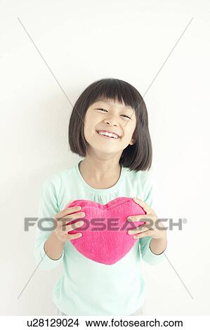 Picture - Girl with Heart Shaped Cushion. Fotosearch