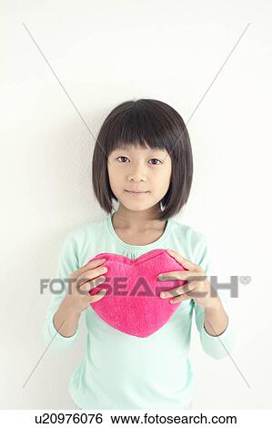 Girl with Heart Shaped Cushion View Large Photo Image Stock Photograph - Girl with Heart Shaped Cushion. Fotosearch