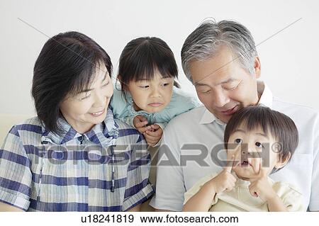 Grandson Pulling a Face, Grandparents and Sister Watching View Large Photo Image Stock Photo - Grandson Pulling a Face, Grandparents and Sister Watching. Fotosearch