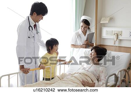 Stock Image - Grandson Visiting Grandmother in Hospital. Fotosearch