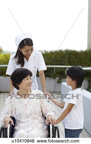 Stock Photo - Grandson Visiting Grandmother in Hospital. Fotosearch