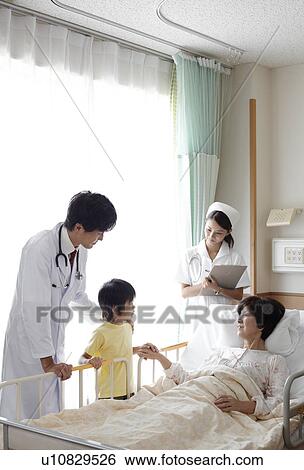 Stock Photograph - Grandson Visiting Grandmother in Hospital. Fotosearch