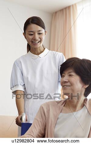 Healthcare Worker and Patient in Wheelchair View Large Photo Image Picture - Healthcare Worker and Patient in Wheelchair. Fotosearch