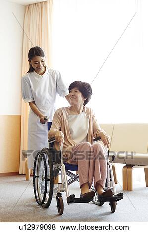 Healthcare Worker and Patient in Wheelchair View Large Photo Image Stock Photo - Healthcare Worker and Patient in Wheelchair. Fotosearch
