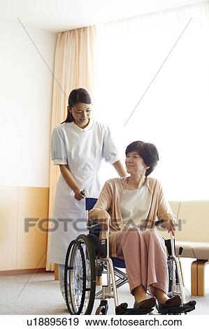Healthcare Worker and Patient in Wheelchair View Large Photo Image Stock Photo - Healthcare Worker and Patient in Wheelchair. Fotosearch