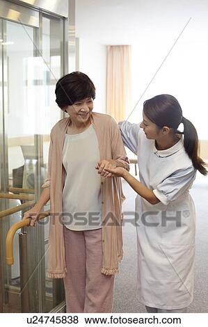 Healthcare Worker Supporting Senior Woman To Walk View Large Photo Image Stock Photo - Healthcare Worker Supporting Senior Woman To Walk. Fotosearch