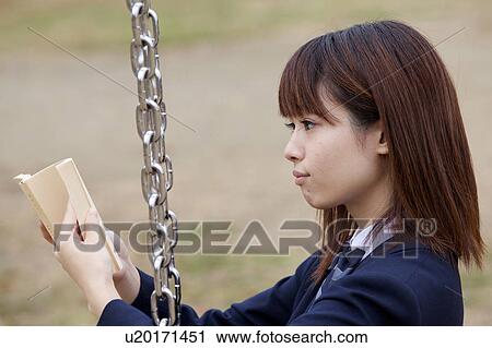 High school girl on a swing reading a book View Large Photo Image Stock Image - High school girl on a swing reading a book. Fotosearch
