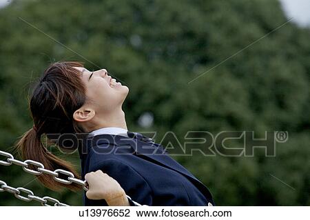 High school girl on a swing View Large Photo Image Stock Image - High school girl on a swing. Fotosearch