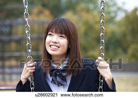 Stock Image - High school girl on a swing. Fotosearch